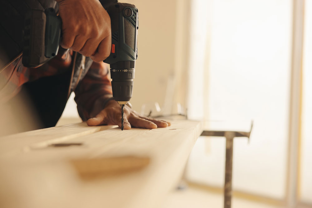 Contractor drilling during a property restoration repair